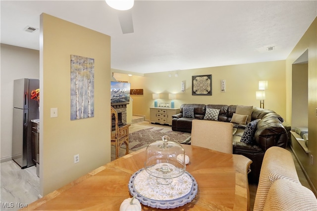 dining room featuring ceiling fan and light wood-type flooring