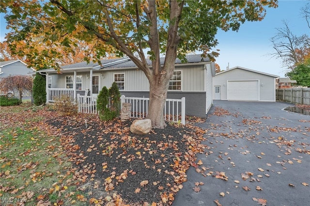 single story home with a garage and an outbuilding