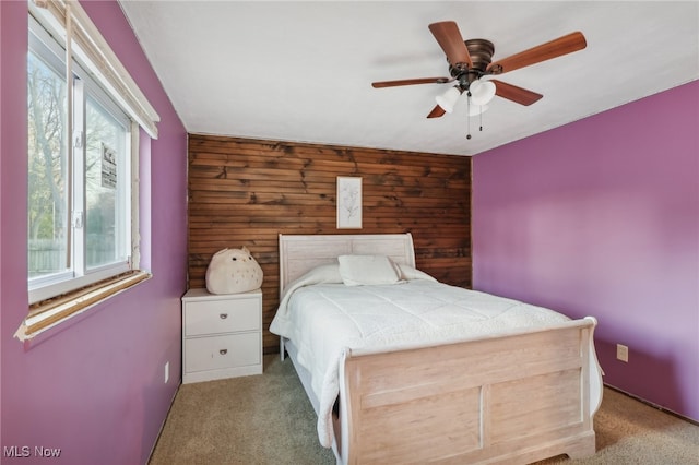 unfurnished bedroom with ceiling fan, multiple windows, and light colored carpet