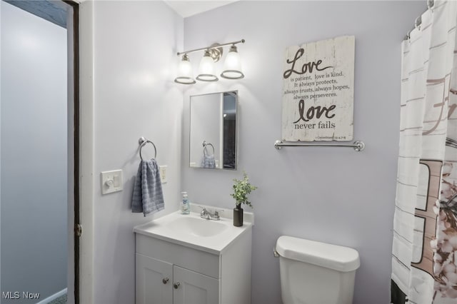 bathroom featuring vanity and toilet