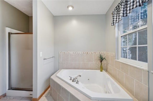 bathroom featuring tile patterned flooring and separate shower and tub