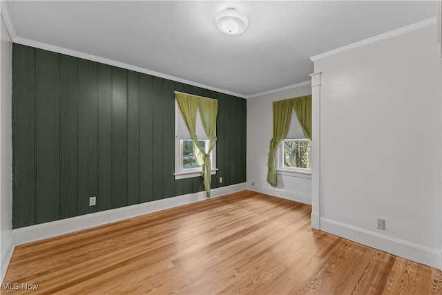 unfurnished room featuring crown molding and light hardwood / wood-style flooring