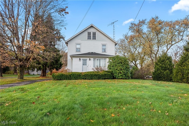 back of house with a lawn