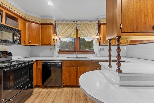 kitchen with black appliances, light wood-type flooring, sink, and crown molding