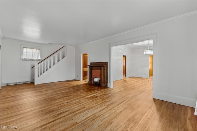 unfurnished living room featuring light hardwood / wood-style floors, a baseboard heating unit, and ornamental molding