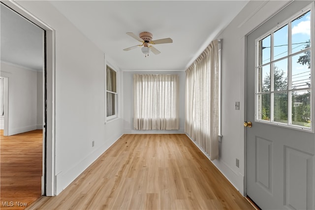 unfurnished sunroom featuring ceiling fan