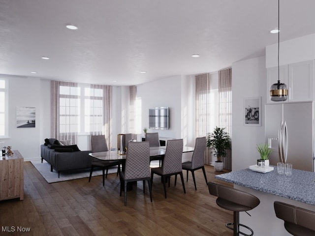 dining area with dark wood-type flooring and a wealth of natural light