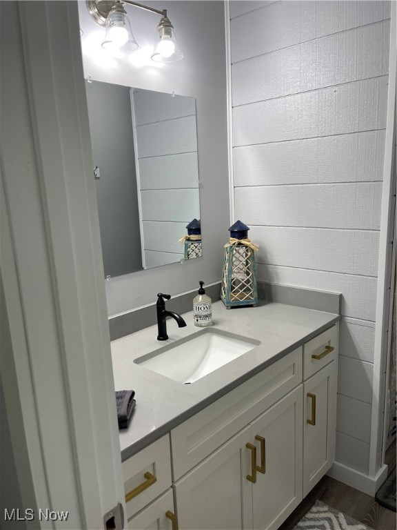 bathroom with hardwood / wood-style flooring and vanity