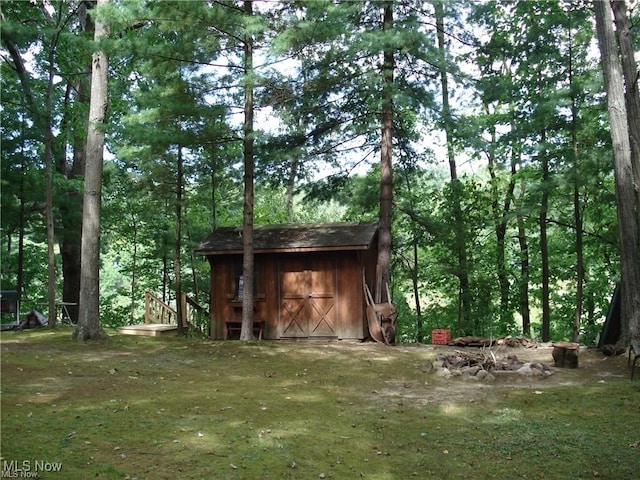 view of outbuilding featuring a yard