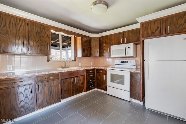 kitchen featuring backsplash, white appliances, sink, and light stone counters