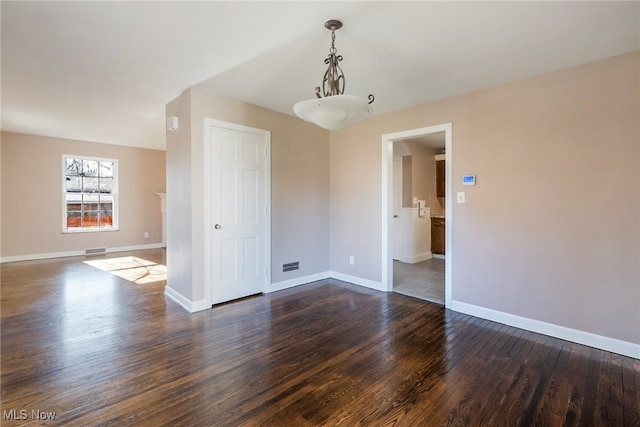 unfurnished room featuring dark hardwood / wood-style floors