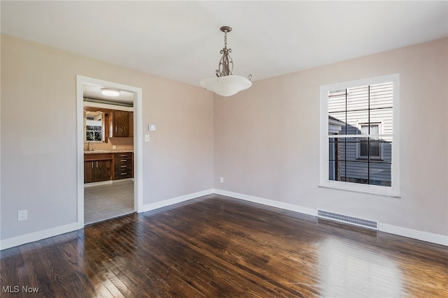 unfurnished room with dark hardwood / wood-style flooring