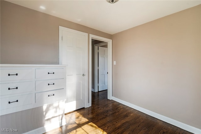 unfurnished bedroom featuring dark hardwood / wood-style floors