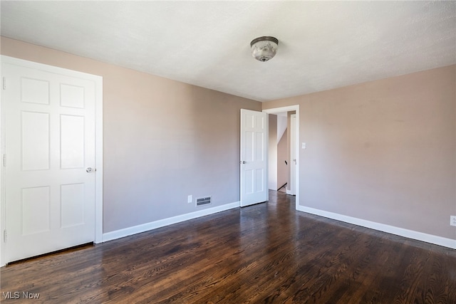 unfurnished room featuring dark hardwood / wood-style flooring