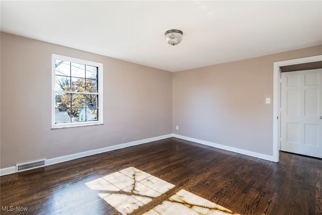 empty room featuring dark wood-type flooring