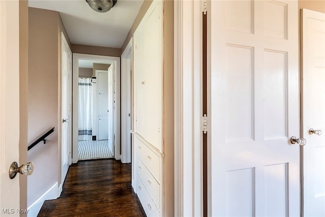 corridor with dark hardwood / wood-style floors