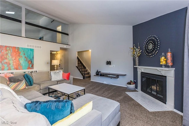 living room with high vaulted ceiling and carpet