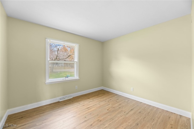 spare room featuring light hardwood / wood-style floors