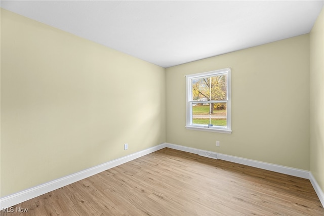 spare room with light hardwood / wood-style flooring