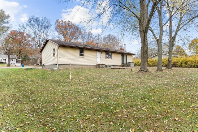 back of property featuring a lawn