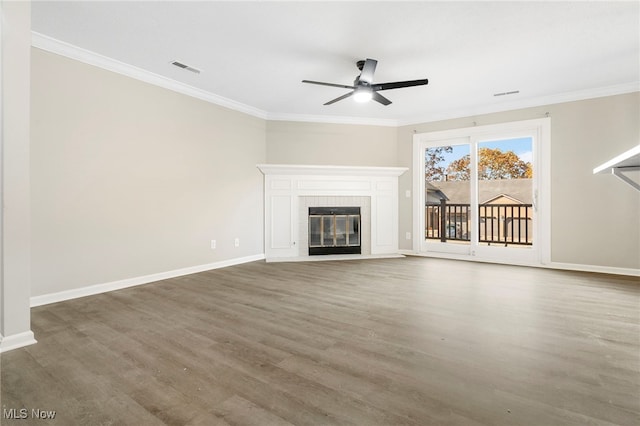 unfurnished living room with ornamental molding, ceiling fan, dark hardwood / wood-style floors, and a fireplace