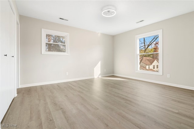 empty room with light hardwood / wood-style flooring