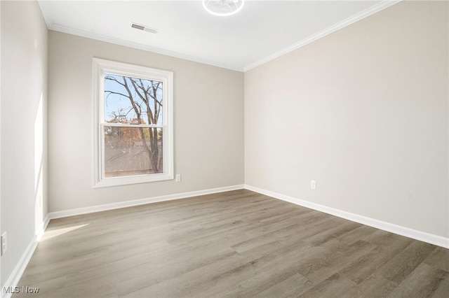 unfurnished room featuring hardwood / wood-style floors and crown molding