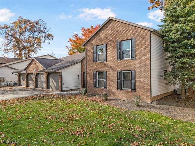 view of front of house with a garage and a front yard