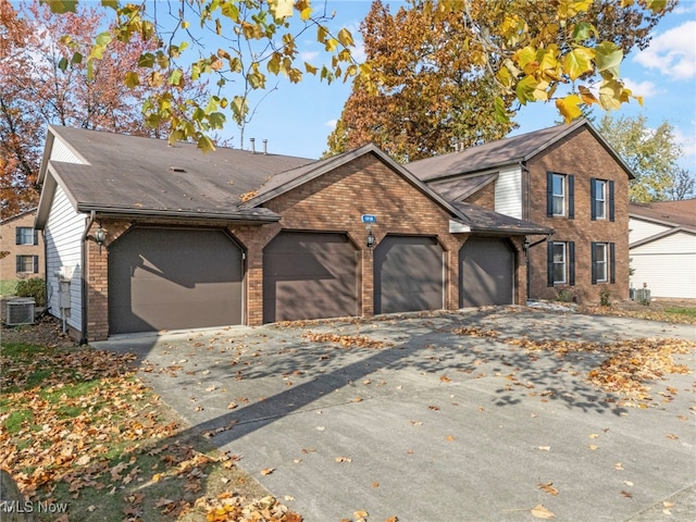 view of front facade with central AC unit and a garage