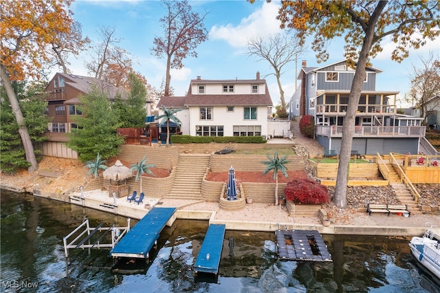 rear view of property with a deck with water view