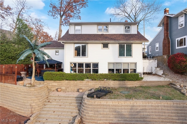 rear view of property featuring a patio area