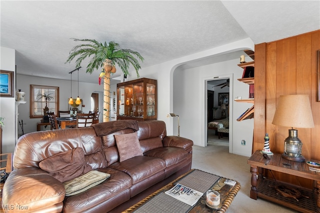 carpeted living room featuring a textured ceiling