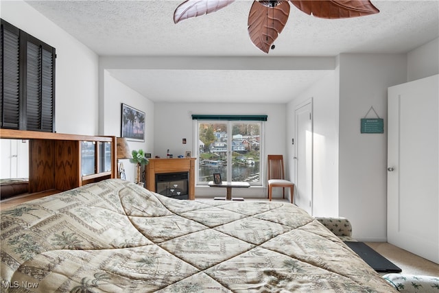 bedroom featuring carpet and a textured ceiling