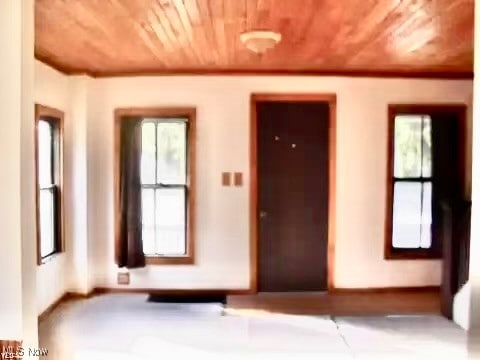 unfurnished room with wooden ceiling