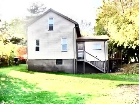 rear view of house featuring a lawn