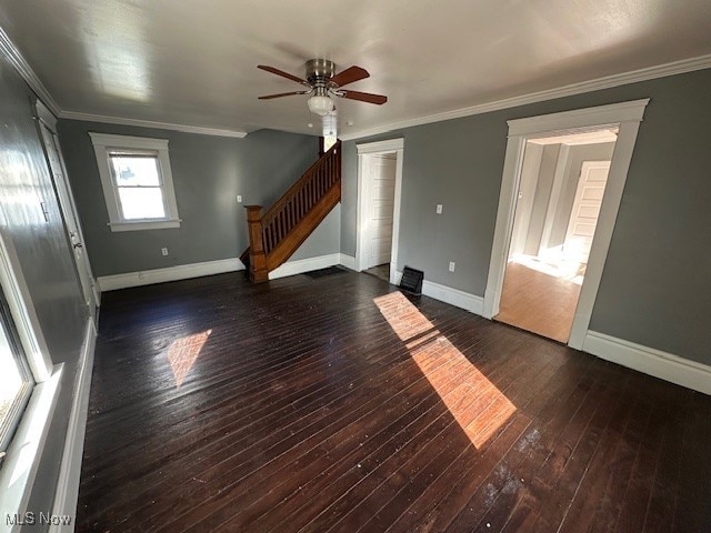 interior space with dark wood-type flooring, ceiling fan, and crown molding