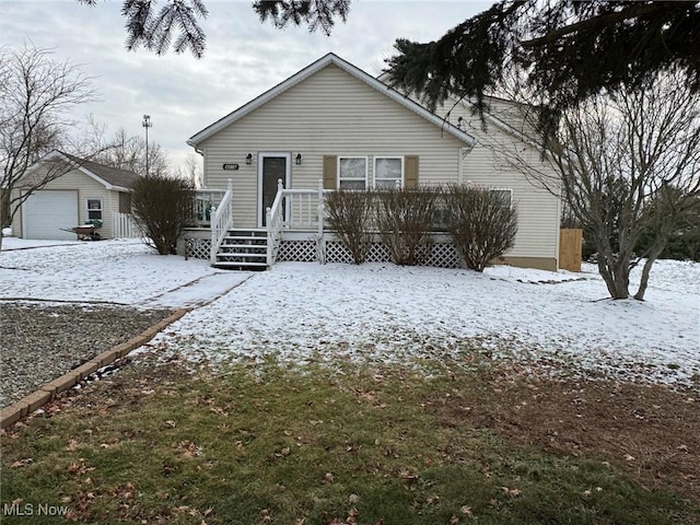 view of front of house with a garage and an outdoor structure