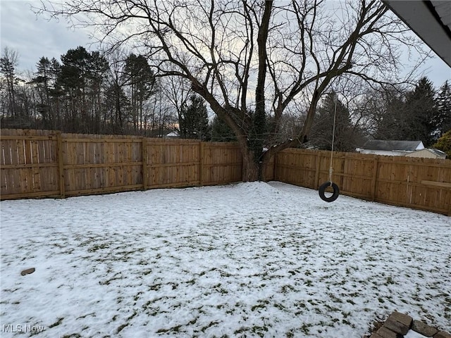 view of yard layered in snow