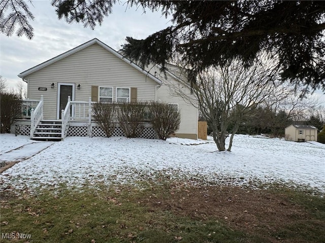 view of front of home featuring a storage shed and a wooden deck