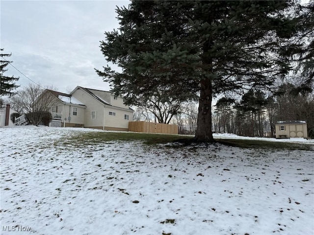 snowy yard with a shed