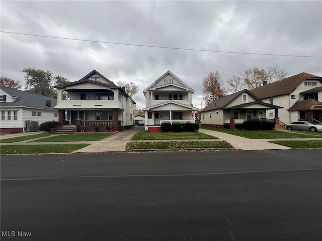 view of front of home with a porch and a front lawn