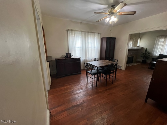 dining space featuring dark hardwood / wood-style flooring, ceiling fan, and plenty of natural light