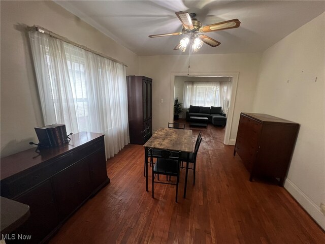 dining area featuring dark wood-type flooring and ceiling fan