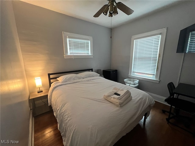 bedroom featuring ceiling fan and dark hardwood / wood-style flooring