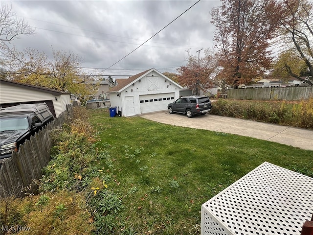 exterior space with a garage, an outbuilding, and a yard