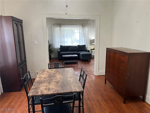 dining space featuring dark wood-type flooring