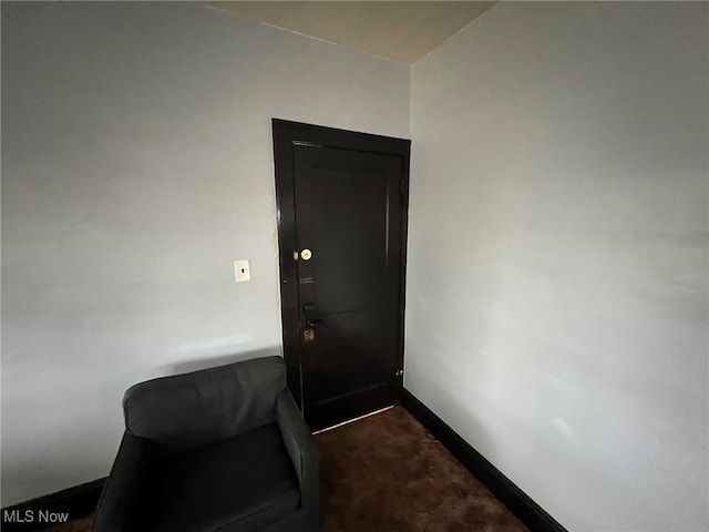 doorway with dark carpet