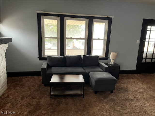 carpeted living room with a fireplace and a wealth of natural light