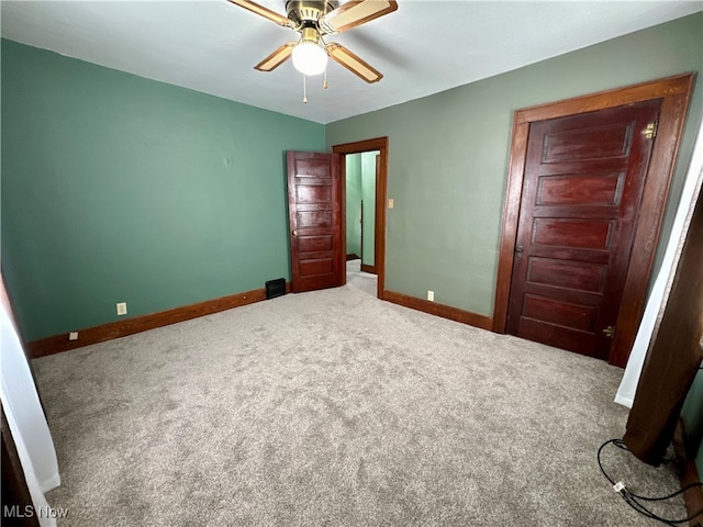 unfurnished bedroom with ceiling fan and carpet