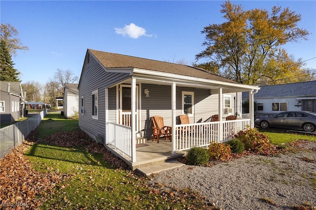 exterior space featuring a yard, cooling unit, and a porch